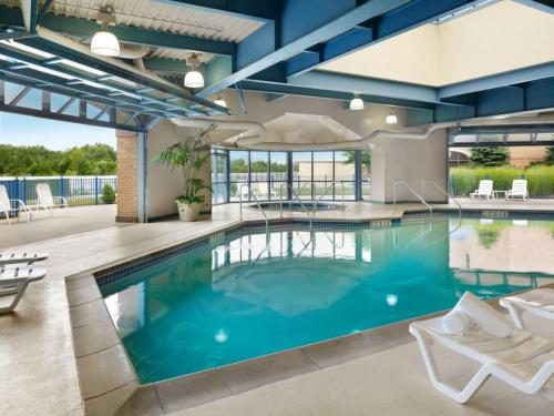 a swimming pool with blue water in a building at Holiday Inn Hotel & Suites Council Bluffs by IHG in Council Bluffs