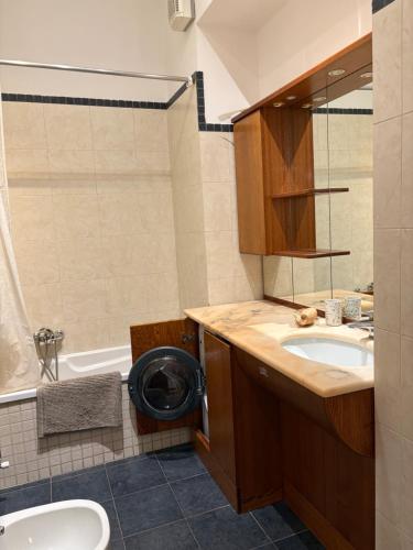 a bathroom with a sink and a toilet and a tub at Roiano Cinque in Trieste