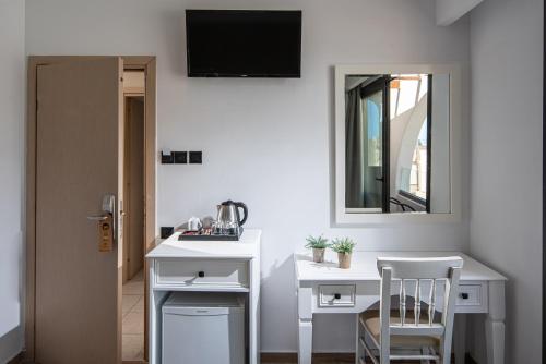 a room with a white desk and a mirror at Georgia's Garden by Omilos Hotels in Amoudara Herakliou