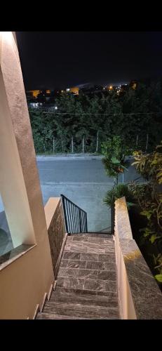 a staircase leading to a balcony of a house at night at White Luxury Villa Apartments &Hot Tab in Durrës