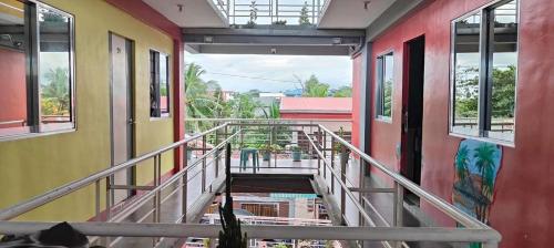 a hallway of a train with windows and a stairway at 4C’s Room Rental, Apartments, Hotel and Transient in Calapan