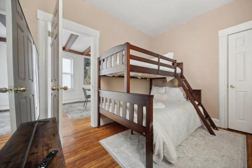 a bedroom with a bunk bed with a ladder at Spacious & Stylish 2BR Apartment Near Manhattan in Jersey City