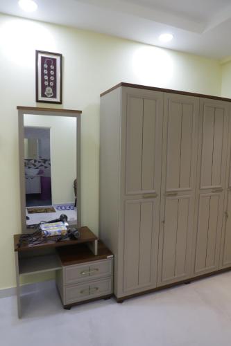 a dressing room with a mirror and a cabinet at V & U Homestay Sadar in Nagpur