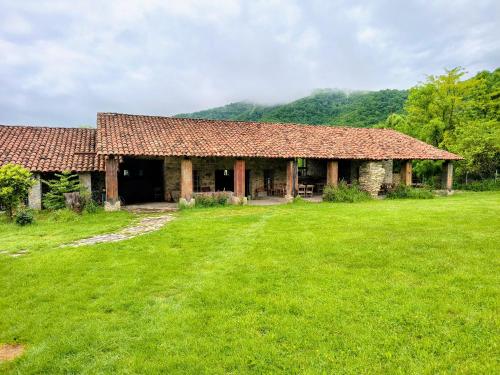 a large building with a grass yard in front of it at Peace Camp Gremi in Gremi