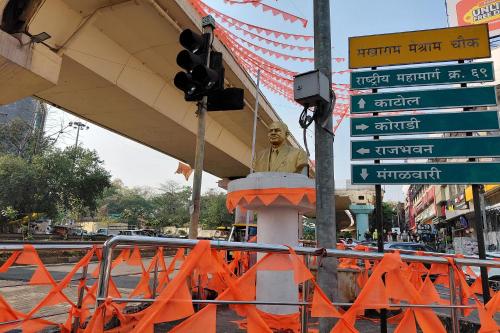a traffic light with a statue in the middle of a street at V & U Homestay Sadar in Nagpur