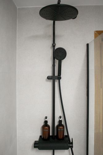 a black shelf with two candles on a wall at Casa Kiwi in Algeciras