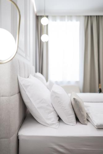 a pile of pillows on a couch with a window at De Pusterla Luxury Rooms in Zadar