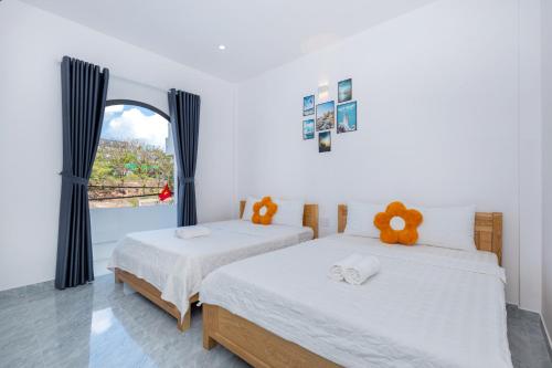 two beds in a room with a window at Villa 17A1 Hồ Quý Ly,Gồm 5 phòng ngủ,Hồ bơi 45m2 in Vung Tau
