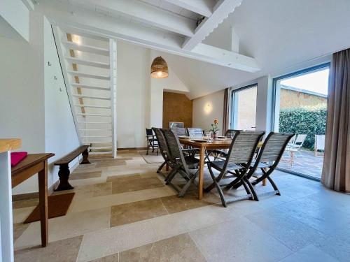 a dining room with a table and chairs at La maison de l'Orangerie - Charm & comfort in the very heart of Carentan in Carentan