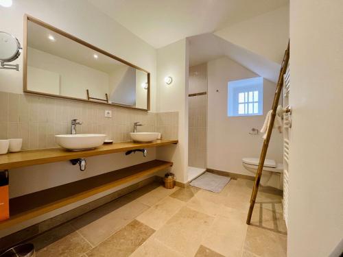 a bathroom with two sinks and a mirror at La maison de l'Orangerie - Charm & comfort in the very heart of Carentan in Carentan