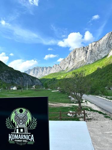 a sign for kommingka with mountains in the background at Komarnica Forest Owl in Šavnik