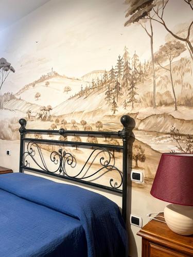 a bedroom with a painting on the wall at Agriturismo B&B La Sterpina in SantʼArcangelo