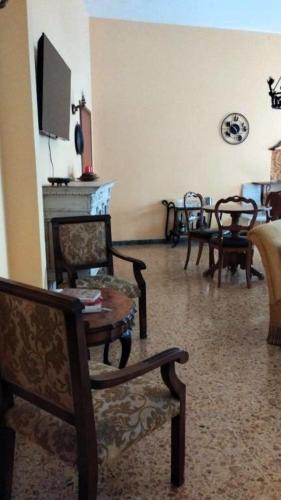 a living room with several chairs and a fireplace at La Dimora Di Anna in Chiusi