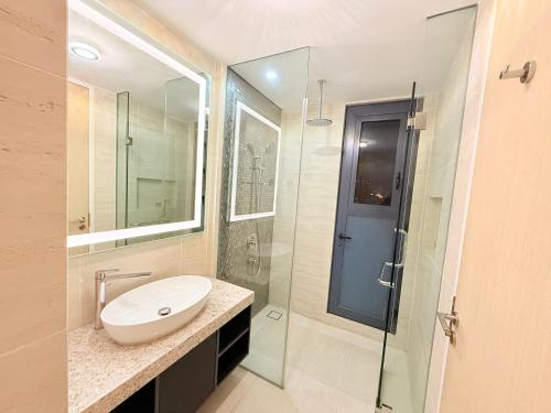 a bathroom with a sink and a glass shower at Star Residence KL in Kuala Lumpur