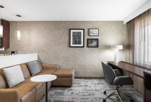 a living room with a couch and a table at Residence Inn by Marriott Des Moines Downtown in Des Moines