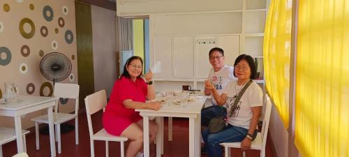 a group of three people sitting at a table at 4C’s Room Rental, Apartments, Hotel and Transient in Calapan