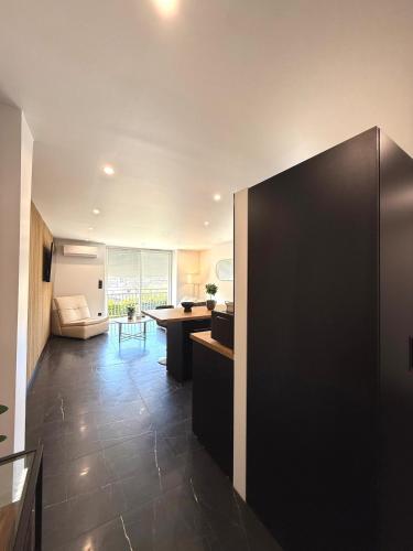 a kitchen with a large black refrigerator in a room at Appartement standing calme in Rodez