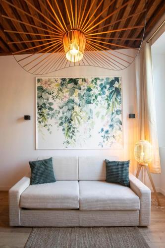 - un canapé dans le salon orné d'une peinture murale dans l'établissement Lassagne - 2, à Lyon