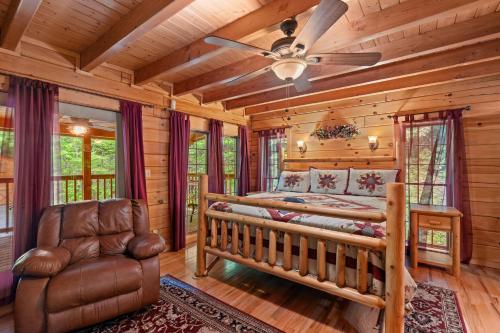 a bedroom with a bed and a couch and a ceiling fan at Elk Rapids on Cosby Creek in Cosby