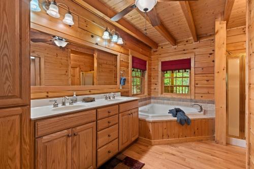 a bathroom with two sinks and a bath tub at Elk Rapids on Cosby Creek in Cosby