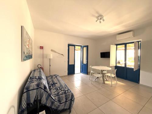 a bedroom with a bed and a table in a room at Case a Malfa - Alba & Rosina, Isola Salina in Malfa