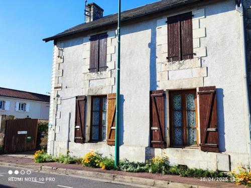 an old white house with wooden shuttered windows at FUTUROGITE in Saint-Georges-lès-Baillargeaux