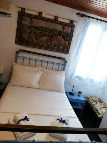 a bedroom with a bed with two towels on it at Auntie's Cottage with View, near Agia Efimia in Loukáta
