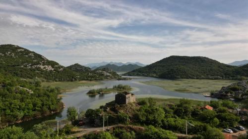 a view of a river with mountains in the background at Studio Apartment Cudo Nevidjeno in Karuč