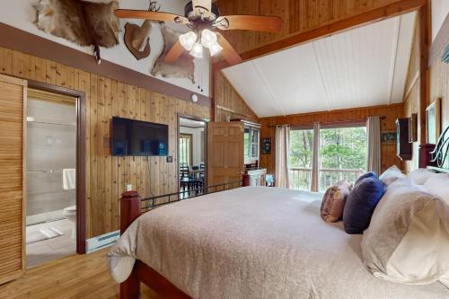 a bedroom with a bed and a ceiling fan at Andreas Creek Cabin #1 in Boone