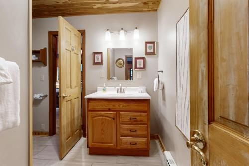 a bathroom with a sink and a mirror at Andreas Creek Cabin #1 in Boone