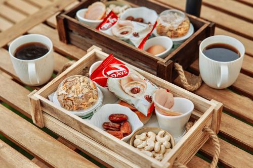 two wooden boxes filled with different types of food at Geometry Park in Ayios Theodhoros