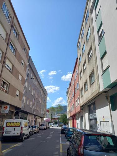 a street with cars parked on the sides of buildings at Home from home in Noya
