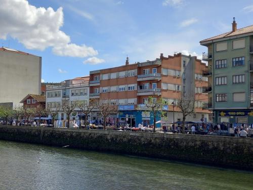 a group of buildings next to a river at Home from home in Noya