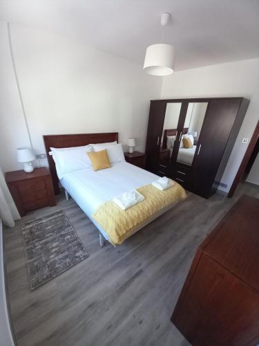 a bedroom with a large bed and a mirror at Home from home in Noya