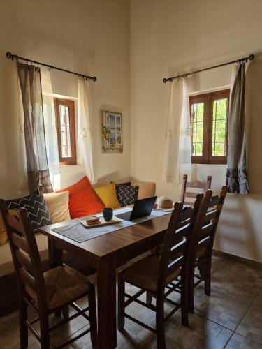a living room with a table and a couch at Villa Penelope Luxury Retreat with Pool & Timeless Charm in Douliana