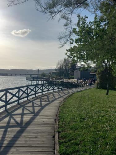 a wooden path next to a body of water at Home from home in Noya
