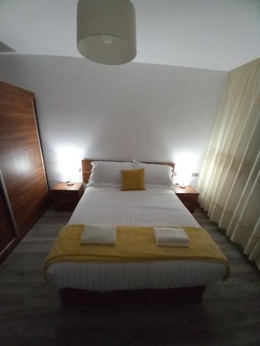 a bedroom with a bed with two towels on it at Home from home in Noya