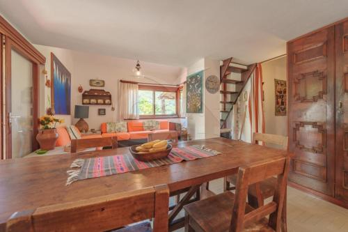 a dining room with a table and a living room at Villa Marilena - Goelba in Fetovaia