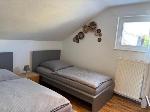 a bedroom with two beds and a window at Wohnzeit-Köln in Cologne