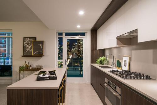 a kitchen with a stove and a counter top at Sky-Rise Apartments in Los Angeles