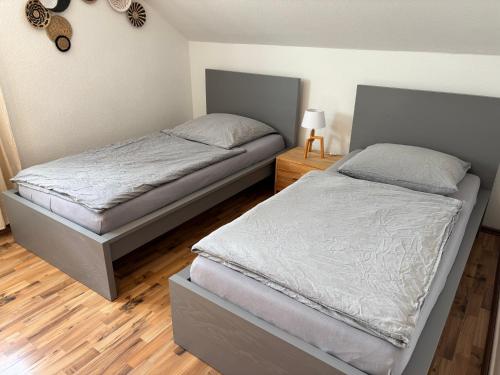 a bedroom with two twin beds and a night stand at Wohnzeit-Köln in Cologne
