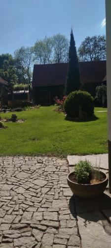 a stone patio with a plant in a pot at Statek Kloubek in Chabičovice