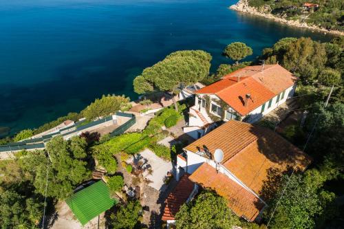 an aerial view of a house with a windmill next to the water at Casa Sabrina in Portoferraio
