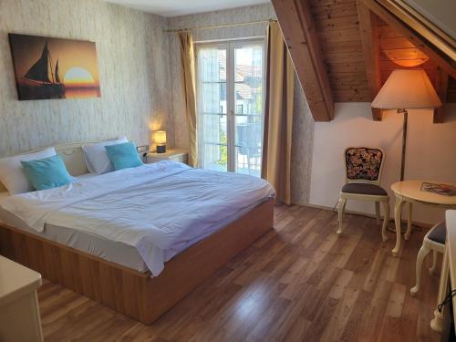 a bedroom with a large bed in a room at SEE-Hotel Seeschau - direkt am Bodenseeufer in Reichenau