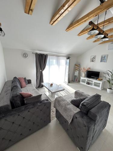 a living room with a couch and a table at Teodora Apartment in Kotor