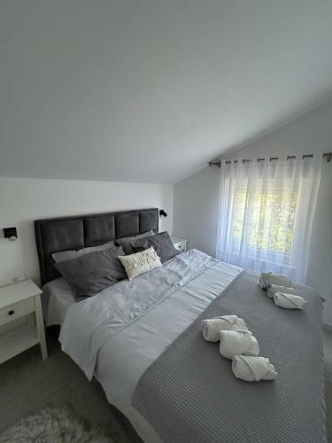 a bedroom with a large bed with towels on it at Teodora Apartment in Kotor