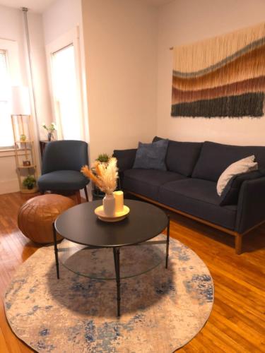 a living room with a couch and a coffee table at 3Beds Apartment in Worcester