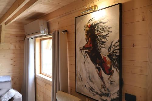 a large painting of a woman hanging on a wall at Portes du Soleil - Zabljak in Žabljak