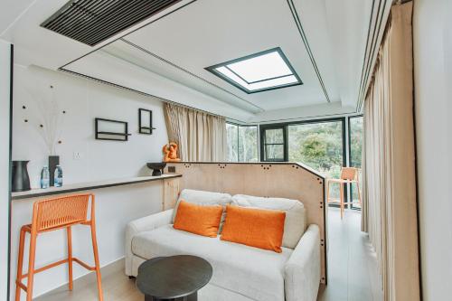 a living room with a couch and a skylight at Geometry Park in Ayios Theodhoros