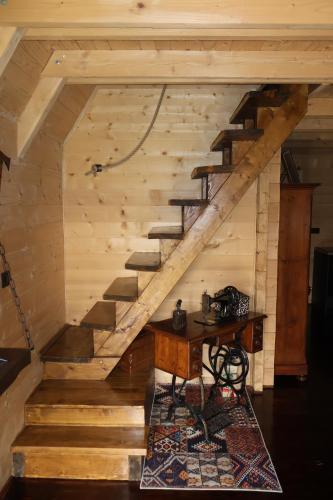 a wooden staircase in a room with a table at Portes du Soleil - Zabljak in Žabljak